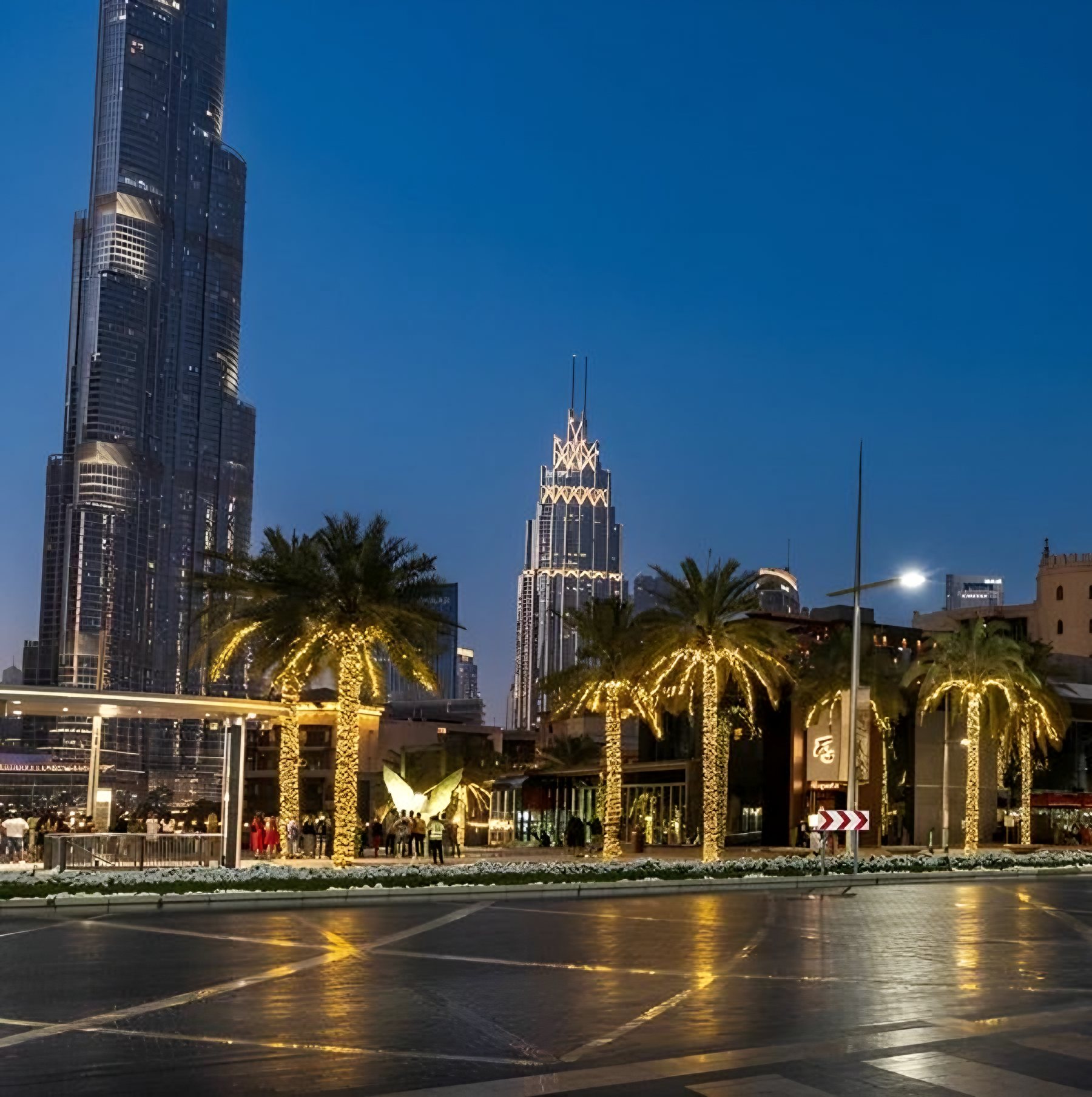 Burj Khalifa and Downtown Dubai’s palm-lined boulevard at dusk